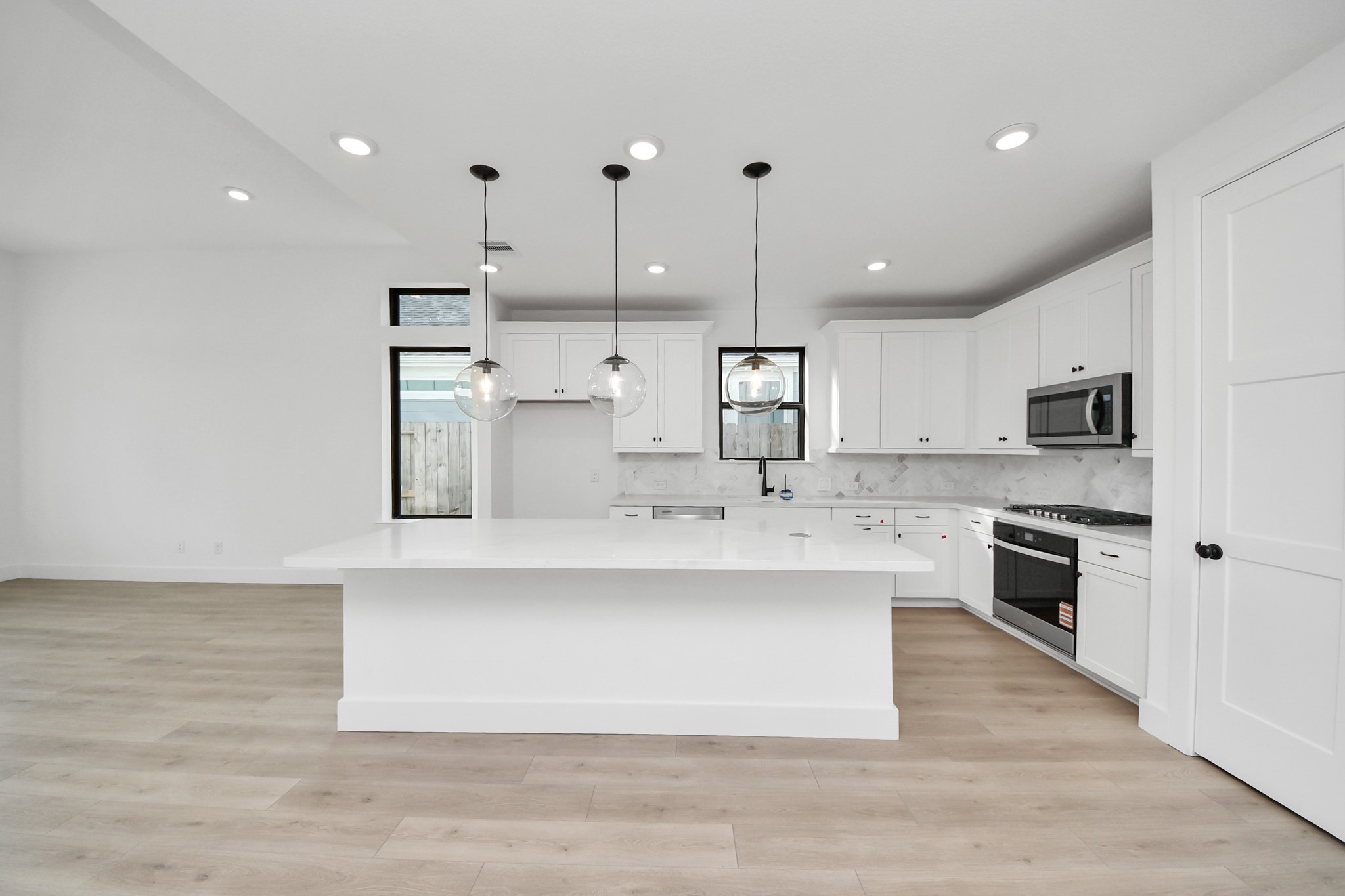 2231 Birch View Lane Katy, TX 77494 - Photo 11 of 40 a large kitchen with stainless steel appliances a large center island attached withe living room