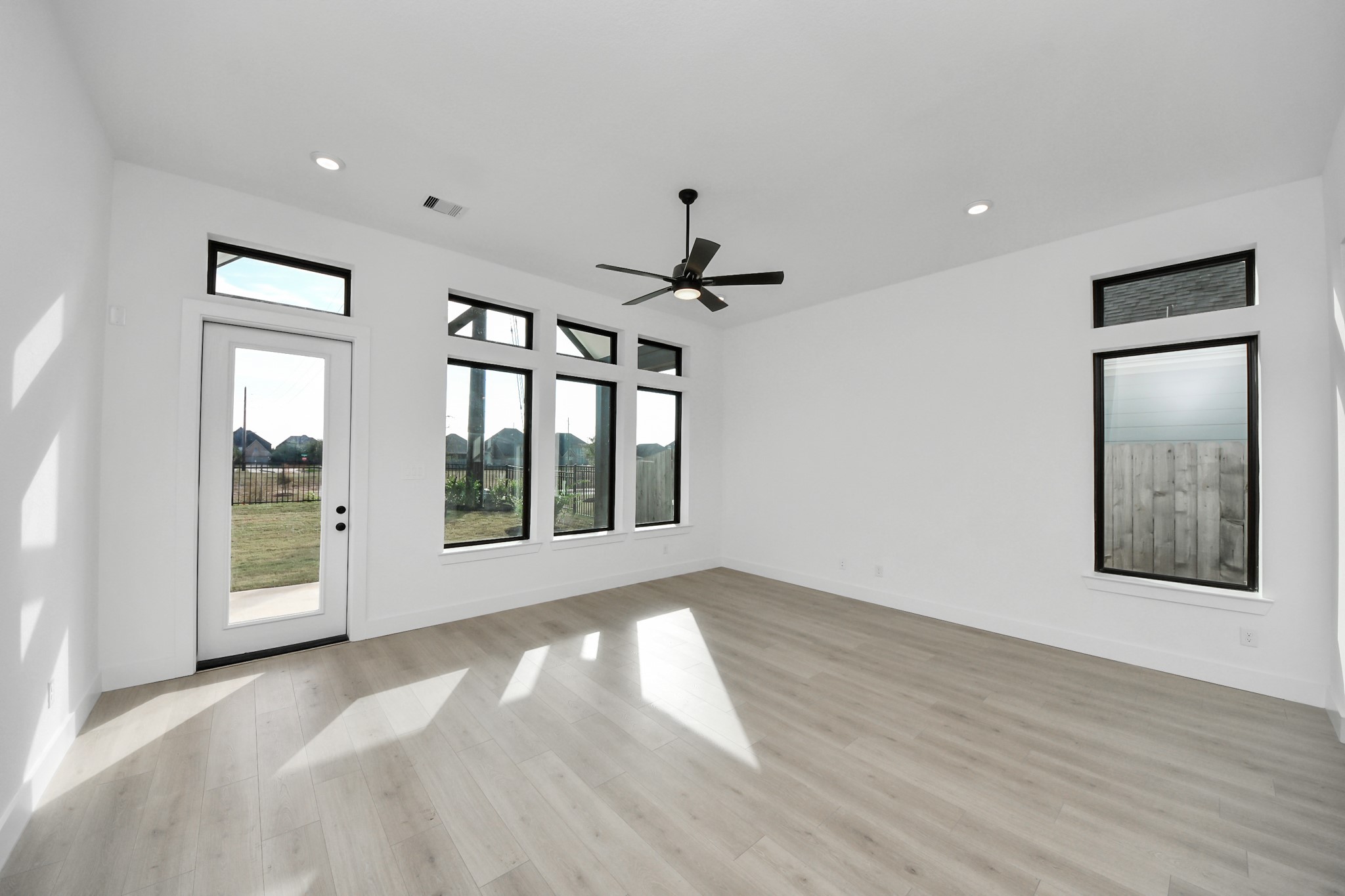 2231 Birch View Lane Katy, TX 77494 - Photo 18 of 40 a view of an empty room with a window and wooden floor