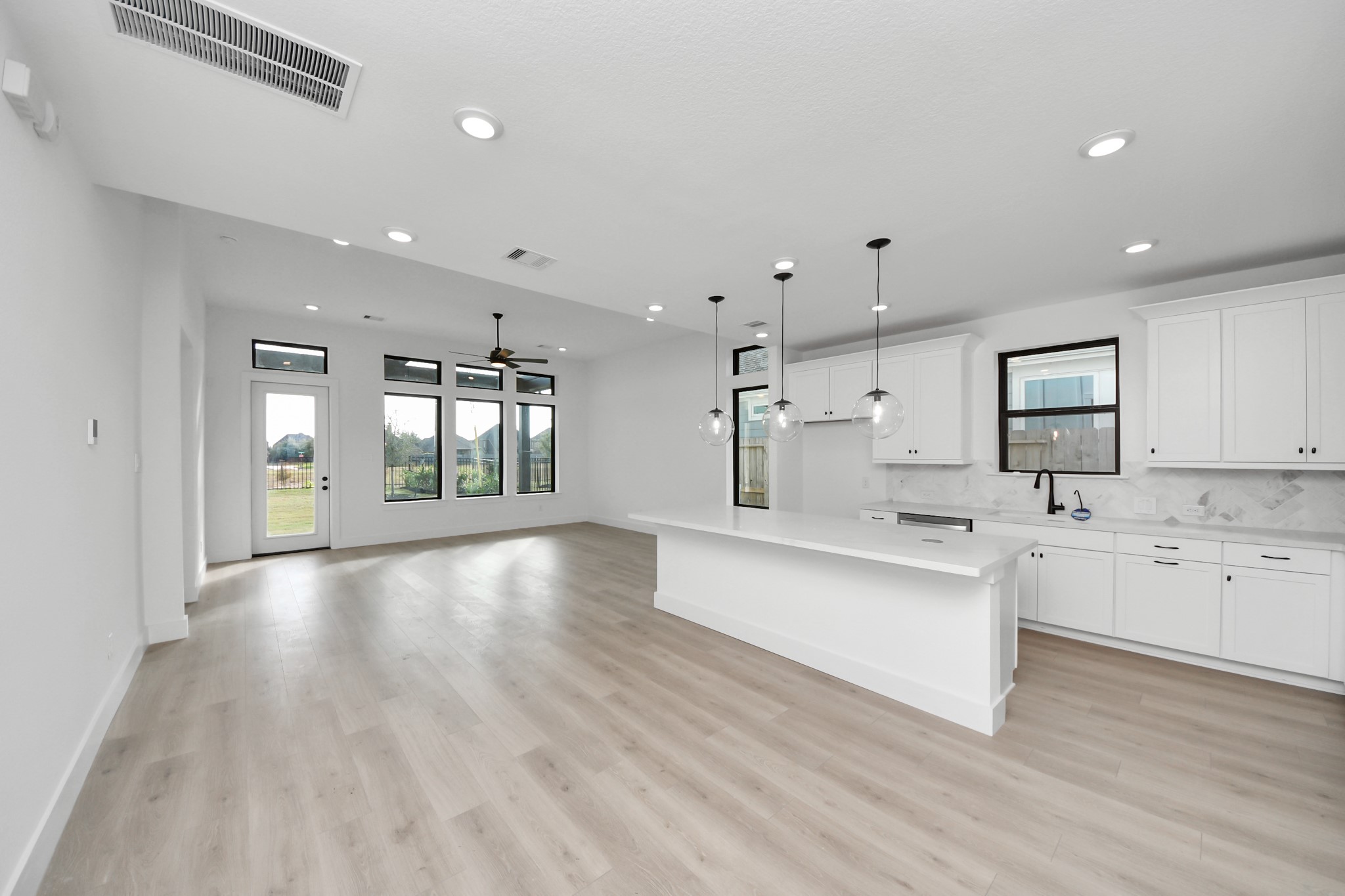2231 Birch View Lane Katy, TX 77494 - Photo 10 of 40 a large white kitchen with kitchen island a sink stainless steel appliances and cabinets