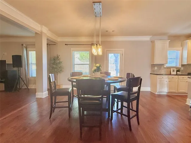 a view of a dining room with furniture window and wooden floor