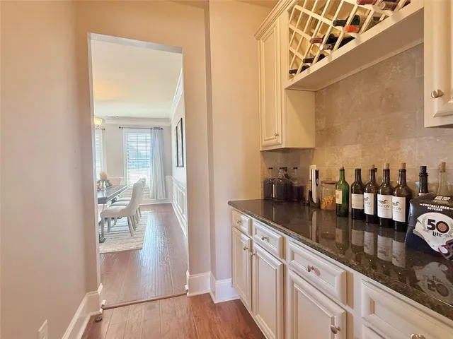 a kitchen with granite countertop a sink a stove and cabinets