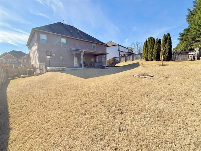 a view of a house with snow on the road