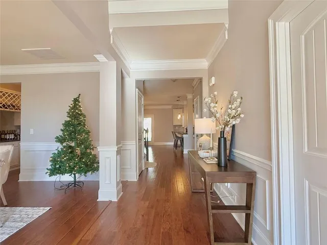 a hallway with dining room and wooden floor