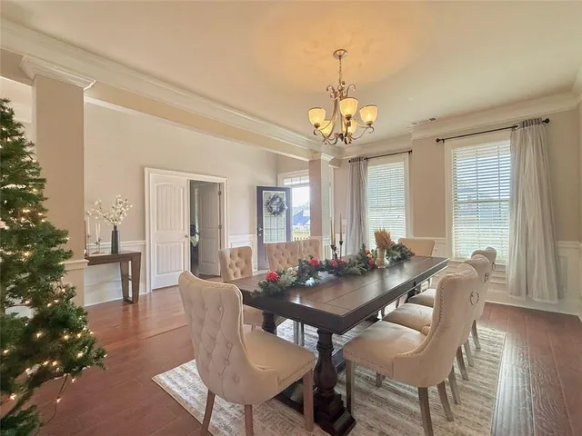a view of a dining room with furniture wooden floor and chandelier