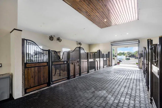 a view of a hallway with wooden stairs