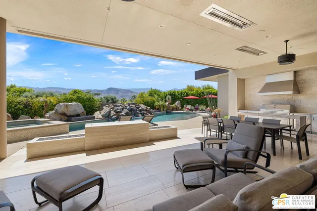 a view of a swimming pool with outdoor seating and plants