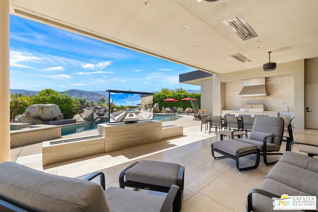 a living room with lots of furniture and a dining table with wooden floor