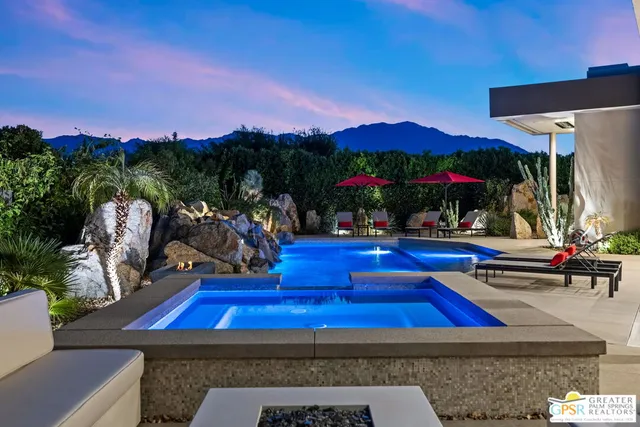 a kitchen with stainless steel appliances granite countertop a kitchen island a stove and a sink