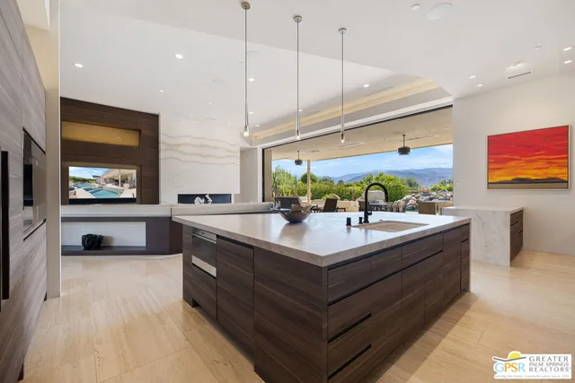 a large kitchen with a table and chairs