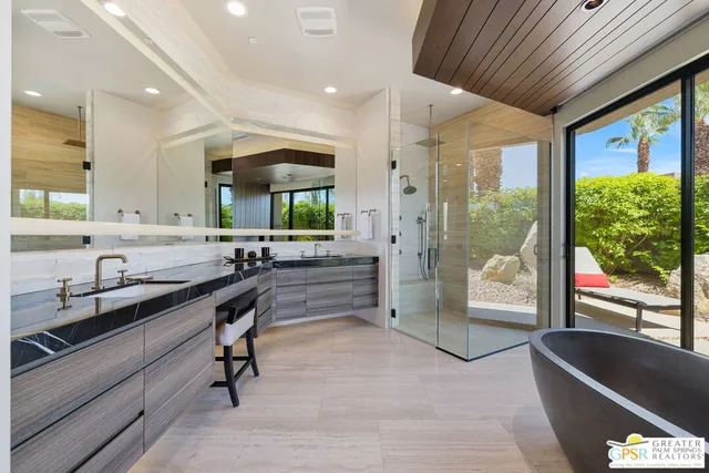 a bathroom with a granite countertop sink a toilet and shower