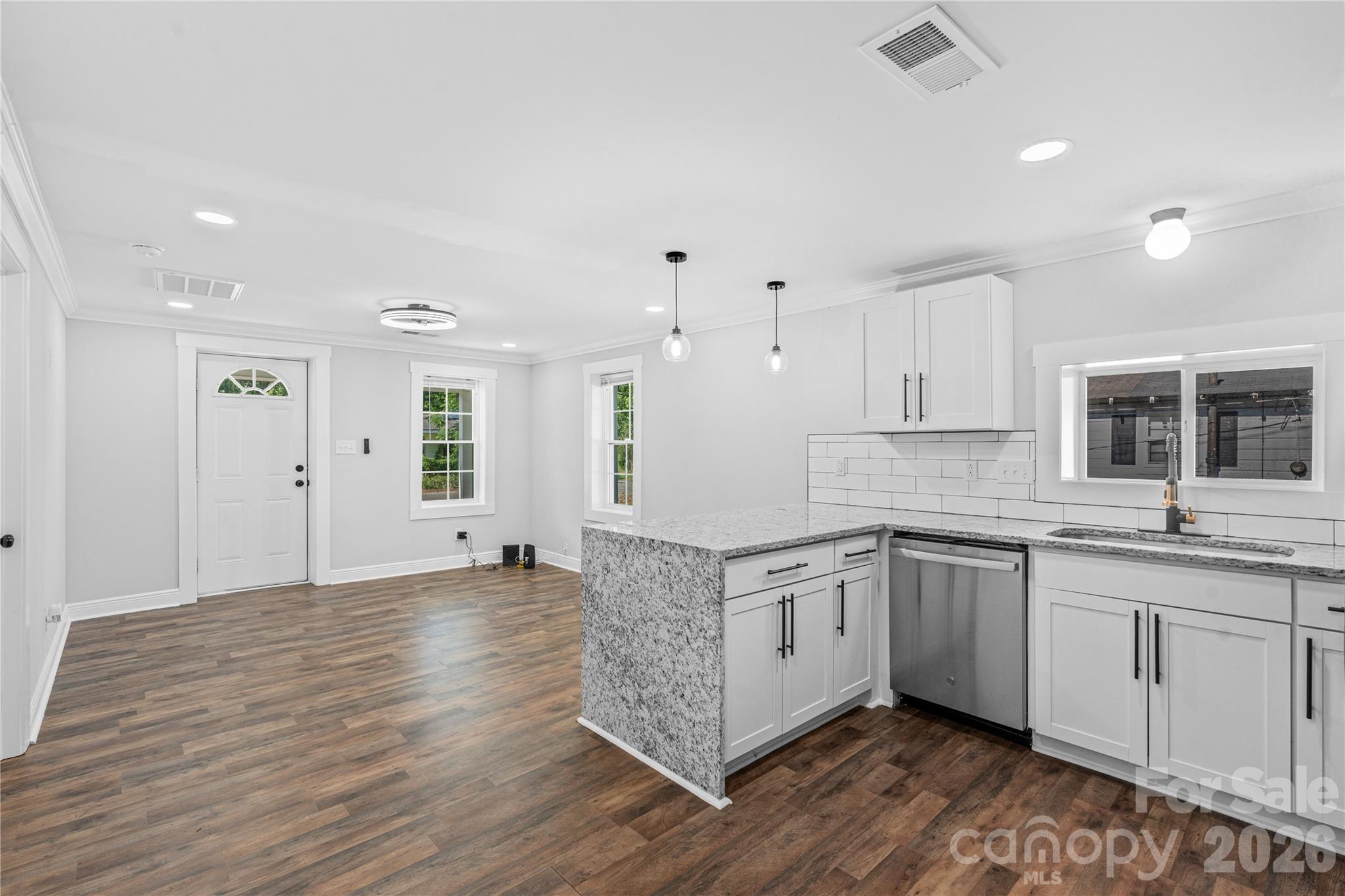 906 Gladstone Street Florence, SC 29501 - Photo 4 of 15 a large kitchen with stainless steel appliances granite countertop a sink and cabinets