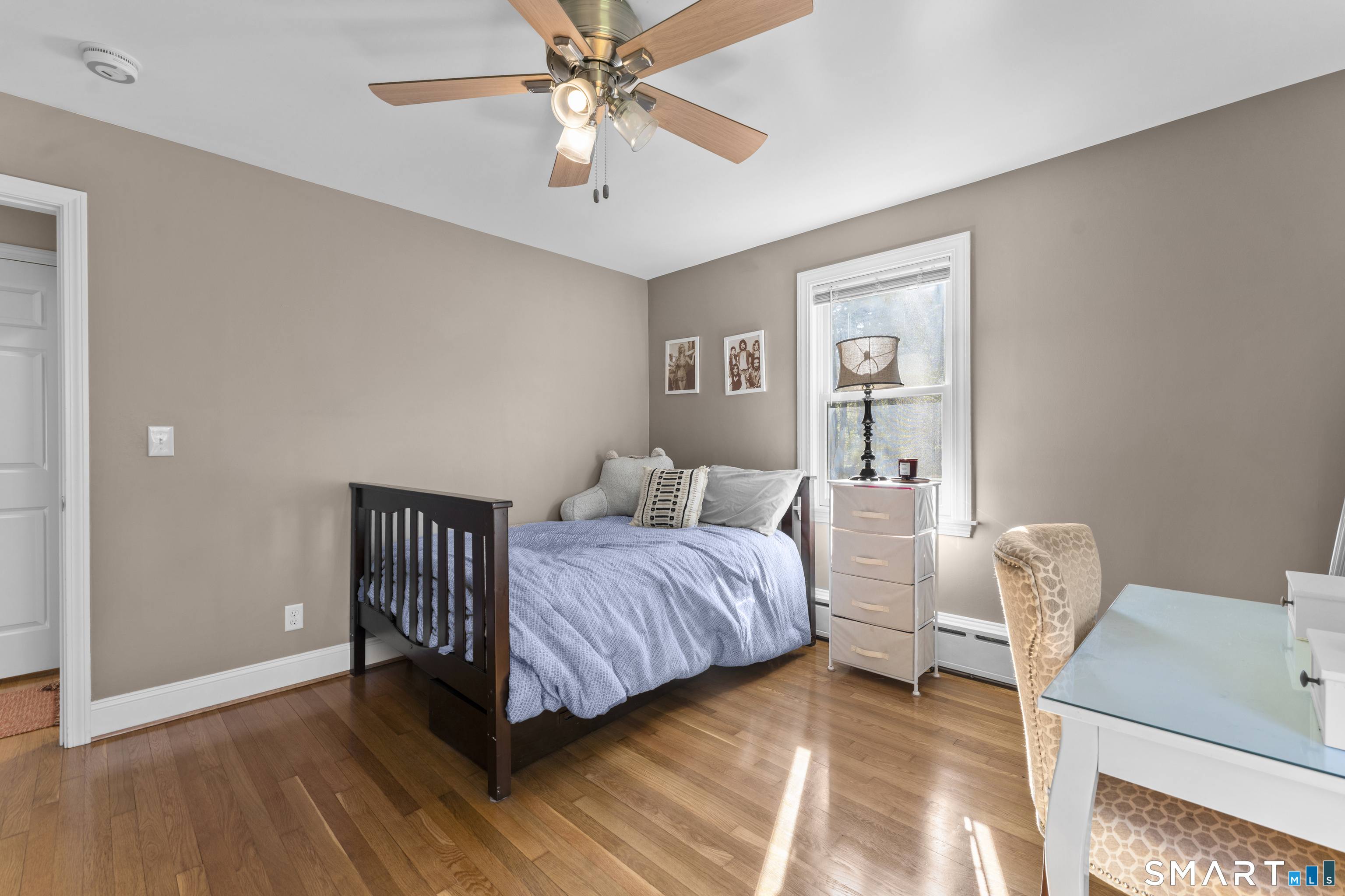 1253 North Street Suffield, CT 06078 - Photo 16 of 33 a bedroom with a bed and a chandelier