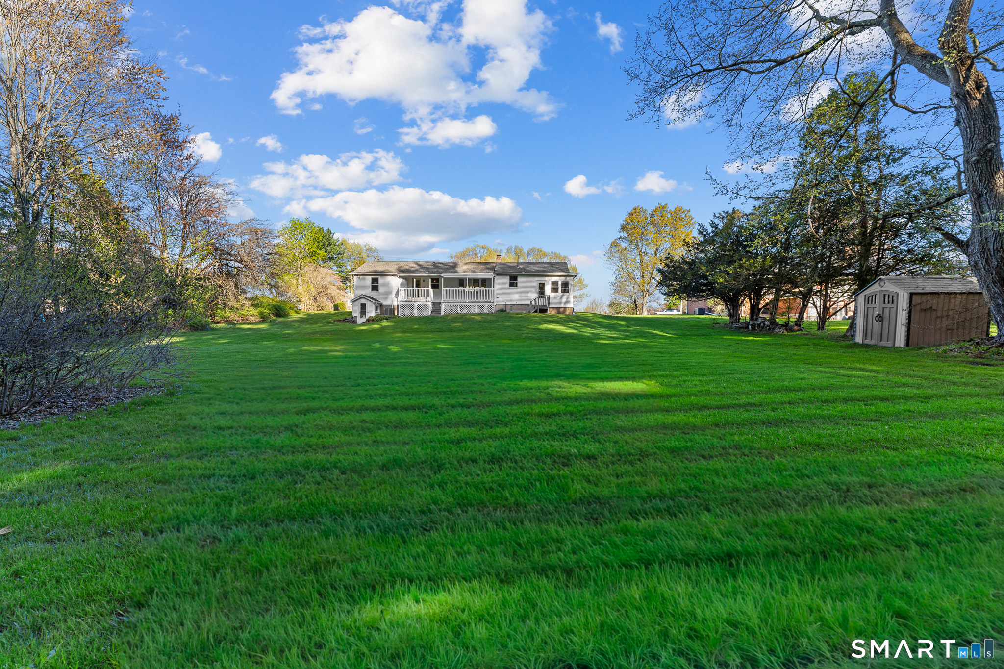 1253 North Street Suffield, CT 06078 - Photo 27 of 33 a view of a big yard with grass and a large tree