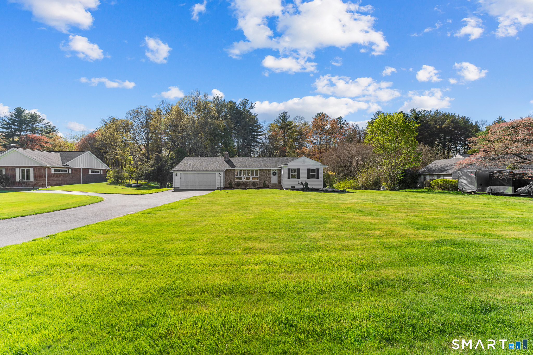 1253 North Street Suffield, CT 06078 - Photo 3 of 33 a swimming pool with trees in the background