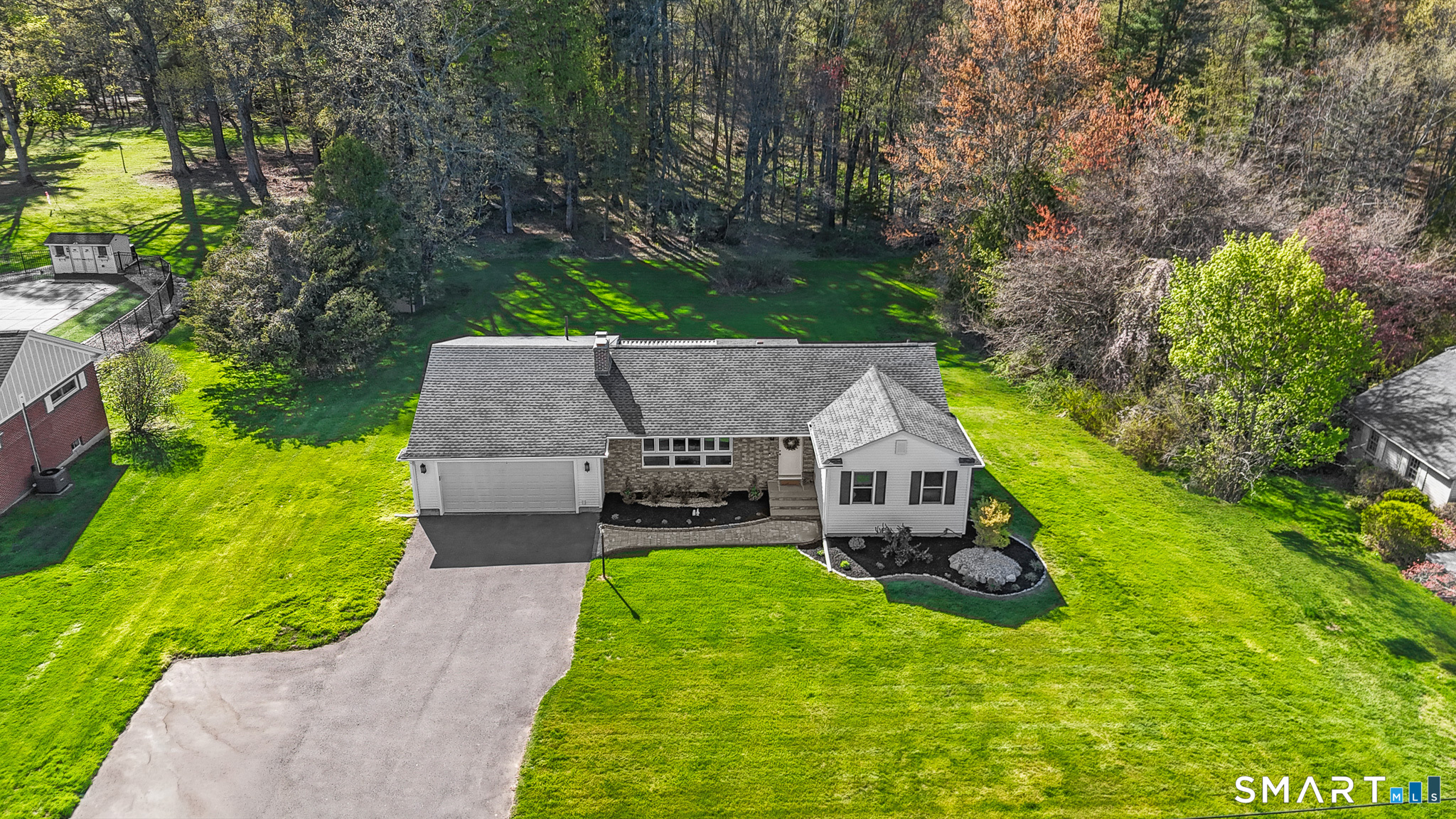 1253 North Street Suffield, CT 06078 - Photo 31 of 33 aerial view of a house with a big yard and potted plants