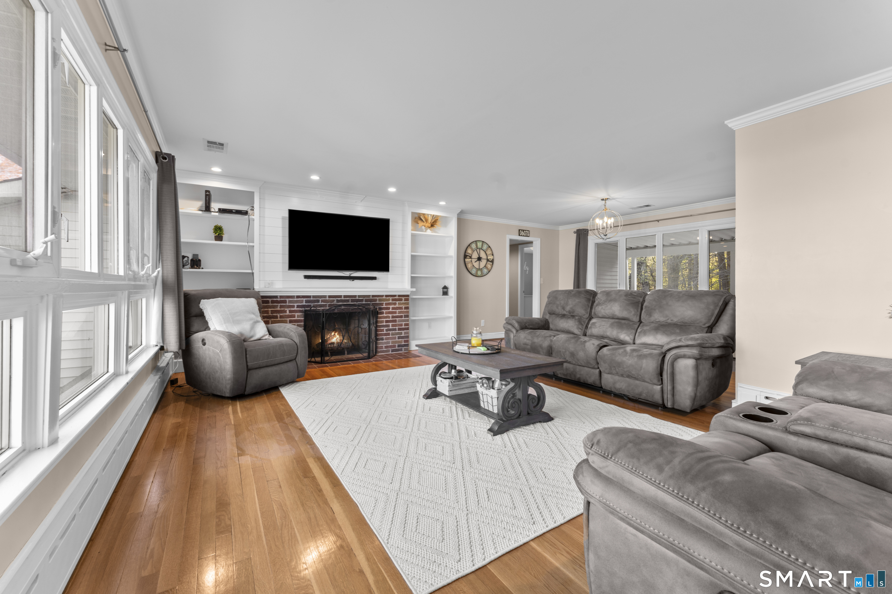1253 North Street Suffield, CT 06078 - Photo 5 of 33 a living room with furniture a flat screen tv and a fireplace