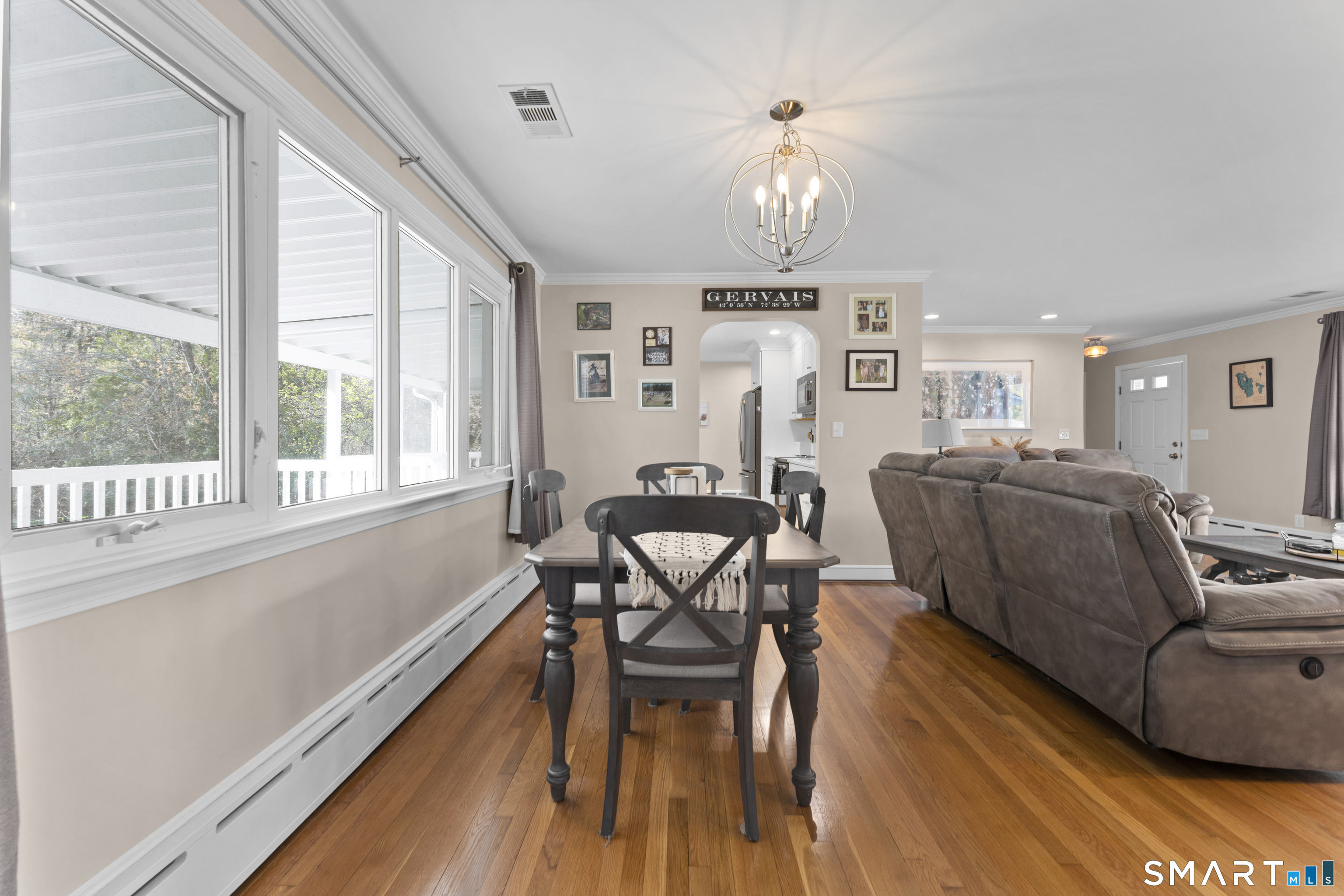 1253 North Street Suffield, CT 06078 - Photo 8 of 33 a view of a dining room with furniture a chandelier and wooden floor