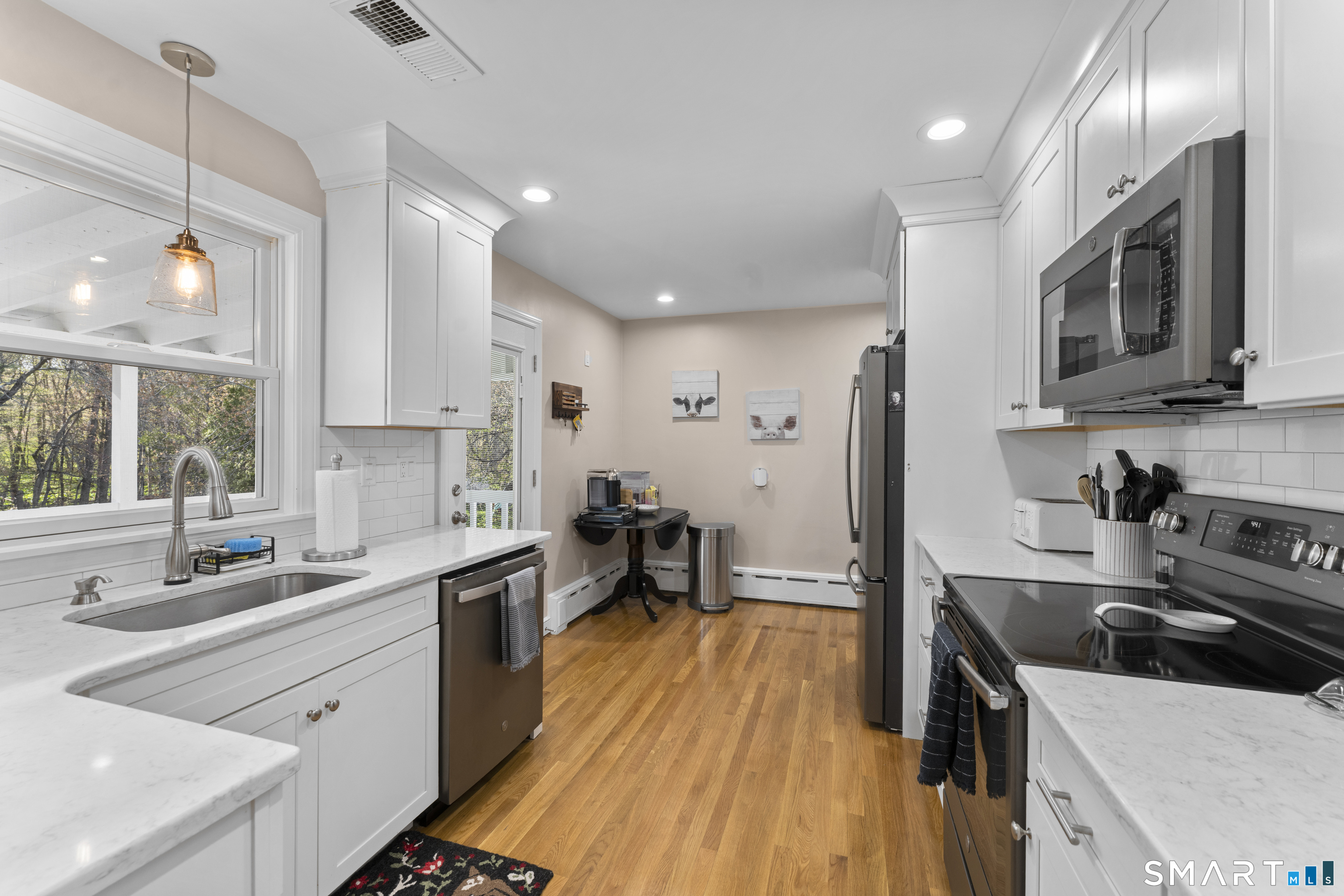 1253 North Street Suffield, CT 06078 - Photo 9 of 33 a kitchen with stainless steel appliances a sink a stove top oven a counter space and cabinets