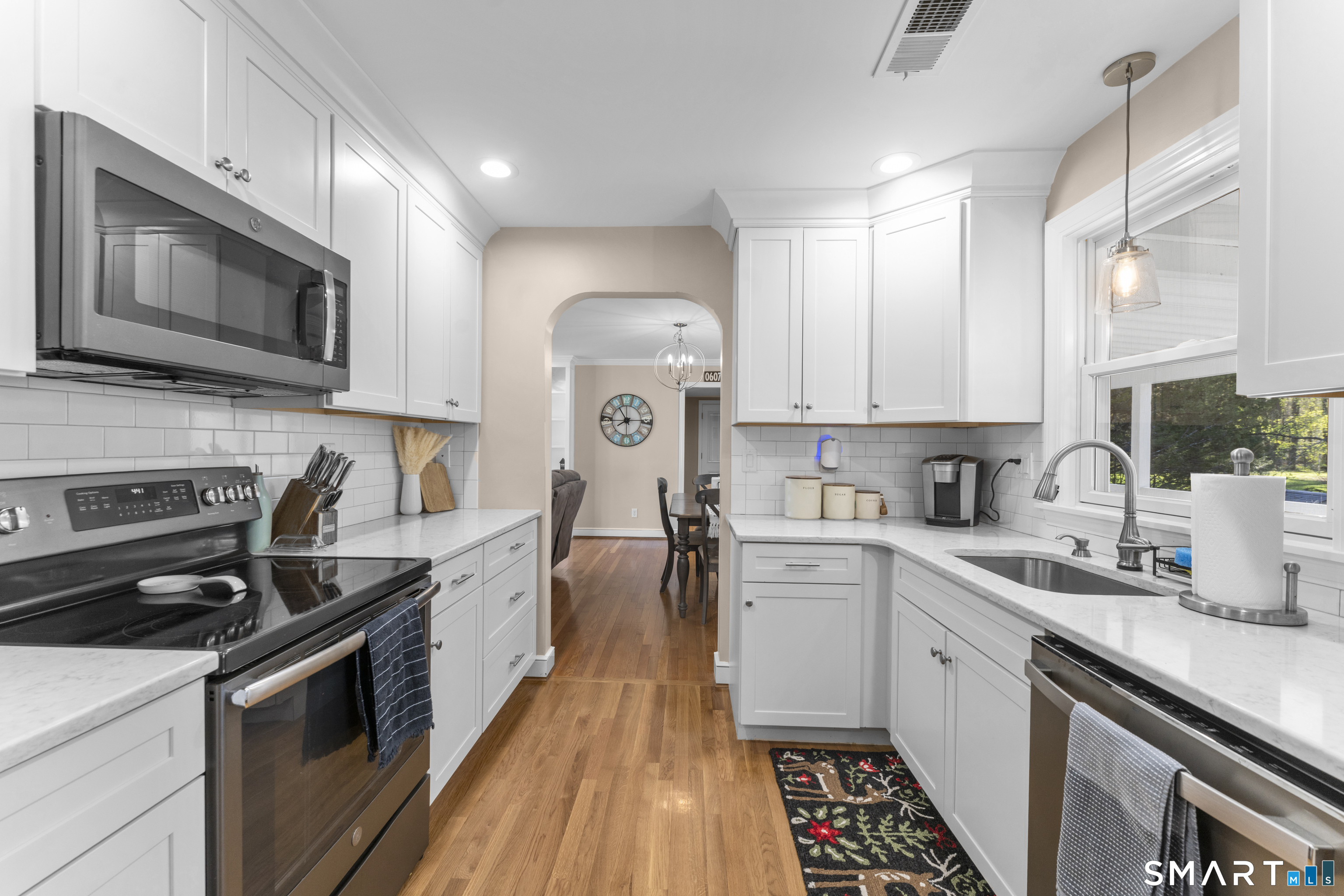 1253 North Street Suffield, CT 06078 - Photo 10 of 33 a kitchen with a sink stove and microwave