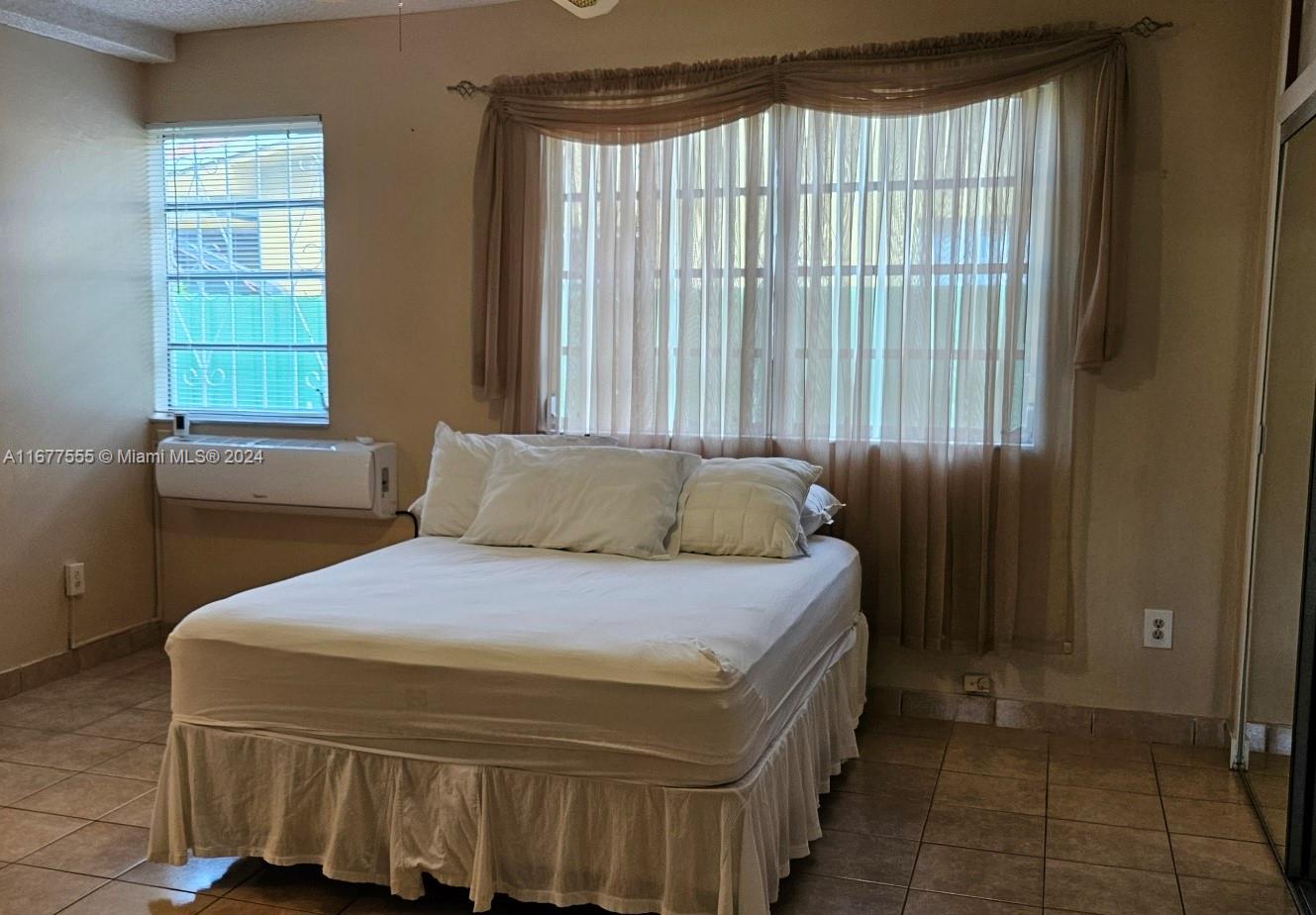 3121 Southwest 23rd Street Miami, FL 33145 - Photo 15 of 31 a bedroom with a bed and a window