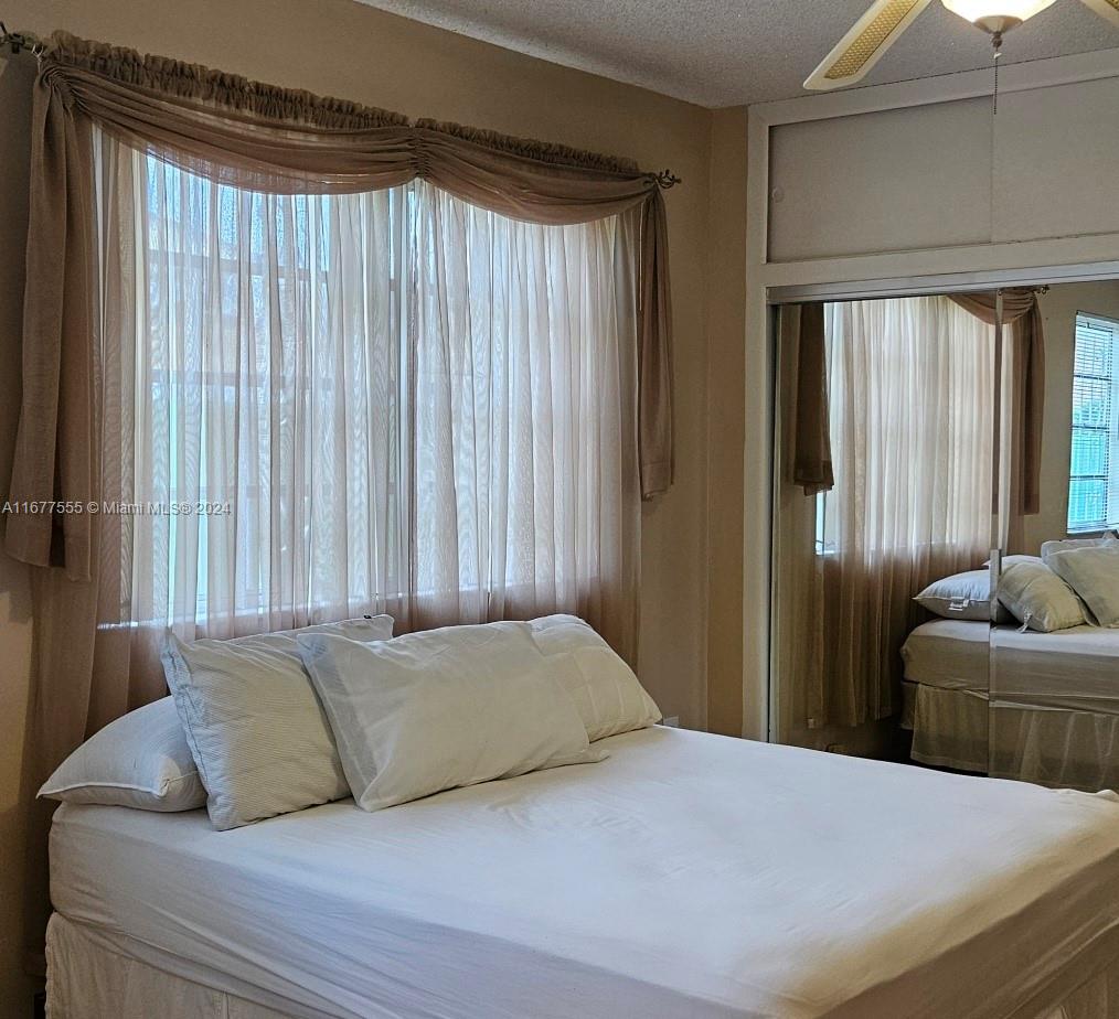 3121 Southwest 23rd Street Miami, FL 33145 - Photo 16 of 31 a bedroom with a bed and glass window