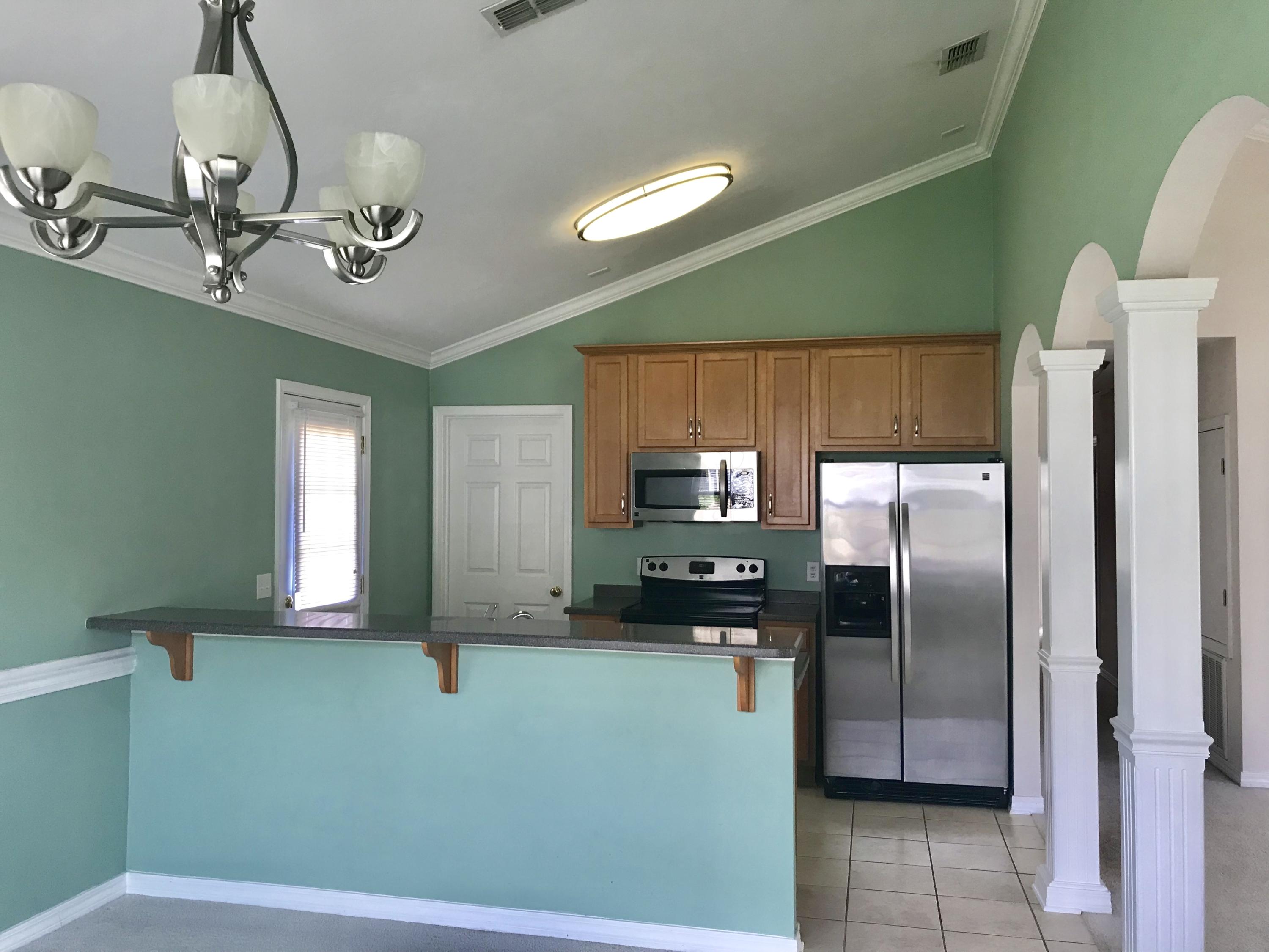 38 4th Street Santa Rosa Beach, FL 32459 - Photo 7 of 22 a kitchen with a refrigerator and a sink