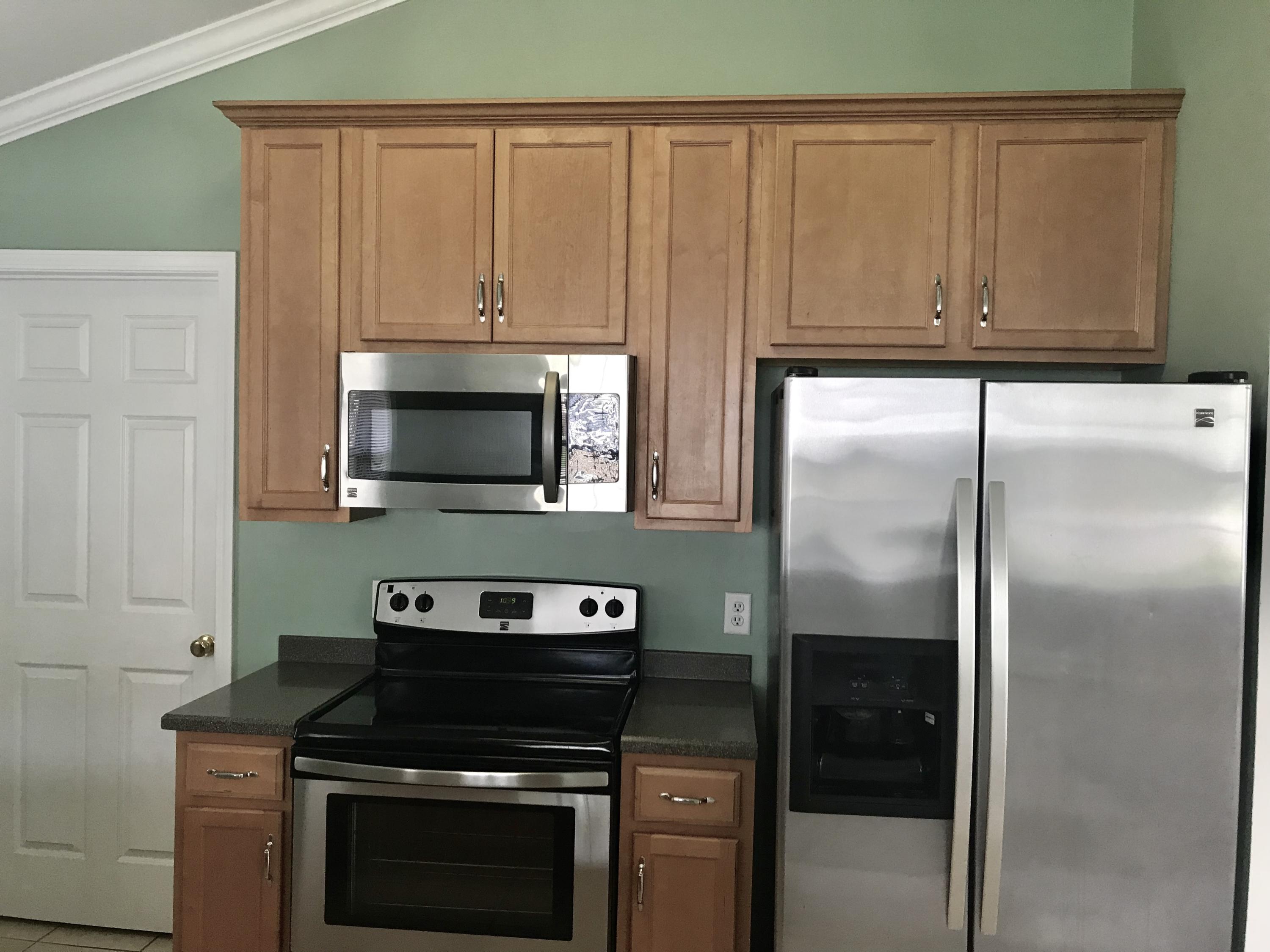38 4th Street Santa Rosa Beach, FL 32459 - Photo 10 of 22 a kitchen with stainless steel appliances wooden cabinets and a stove