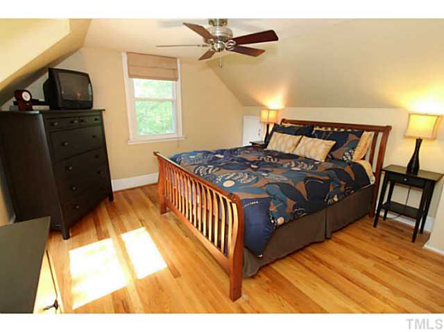 308 Colleton Road Raleigh, NC 27610 - Photo 10 of 25 a bedroom with a bed and wooden floor