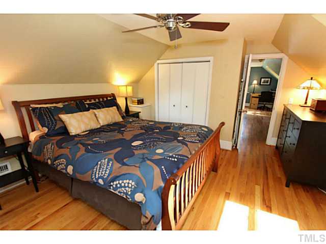308 Colleton Road Raleigh, NC 27610 - Photo 11 of 25 a bedroom with a bed and wooden floor