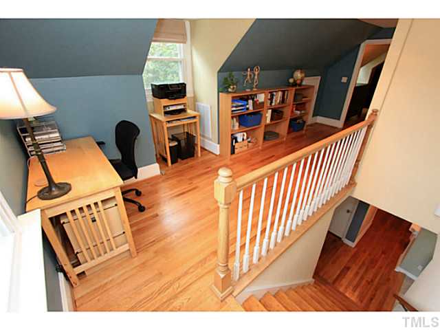 308 Colleton Road Raleigh, NC 27610 - Photo 14 of 25 a view of a workspace with furniture and a book shelf