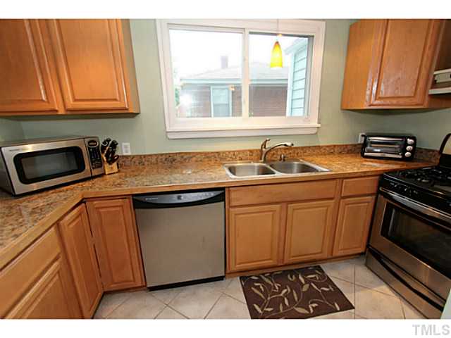 308 Colleton Road Raleigh, NC 27610 - Photo 2 of 25 a kitchen with stainless steel appliances granite countertop a sink stove and cabinets