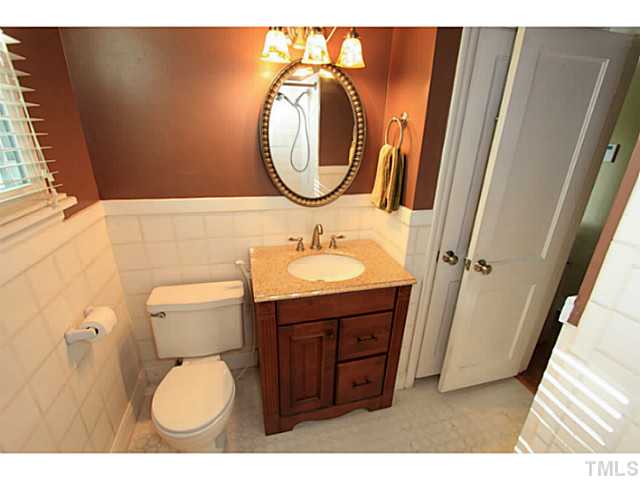 308 Colleton Road Raleigh, NC 27610 - Photo 8 of 25 a bathroom with a toilet sink and mirror