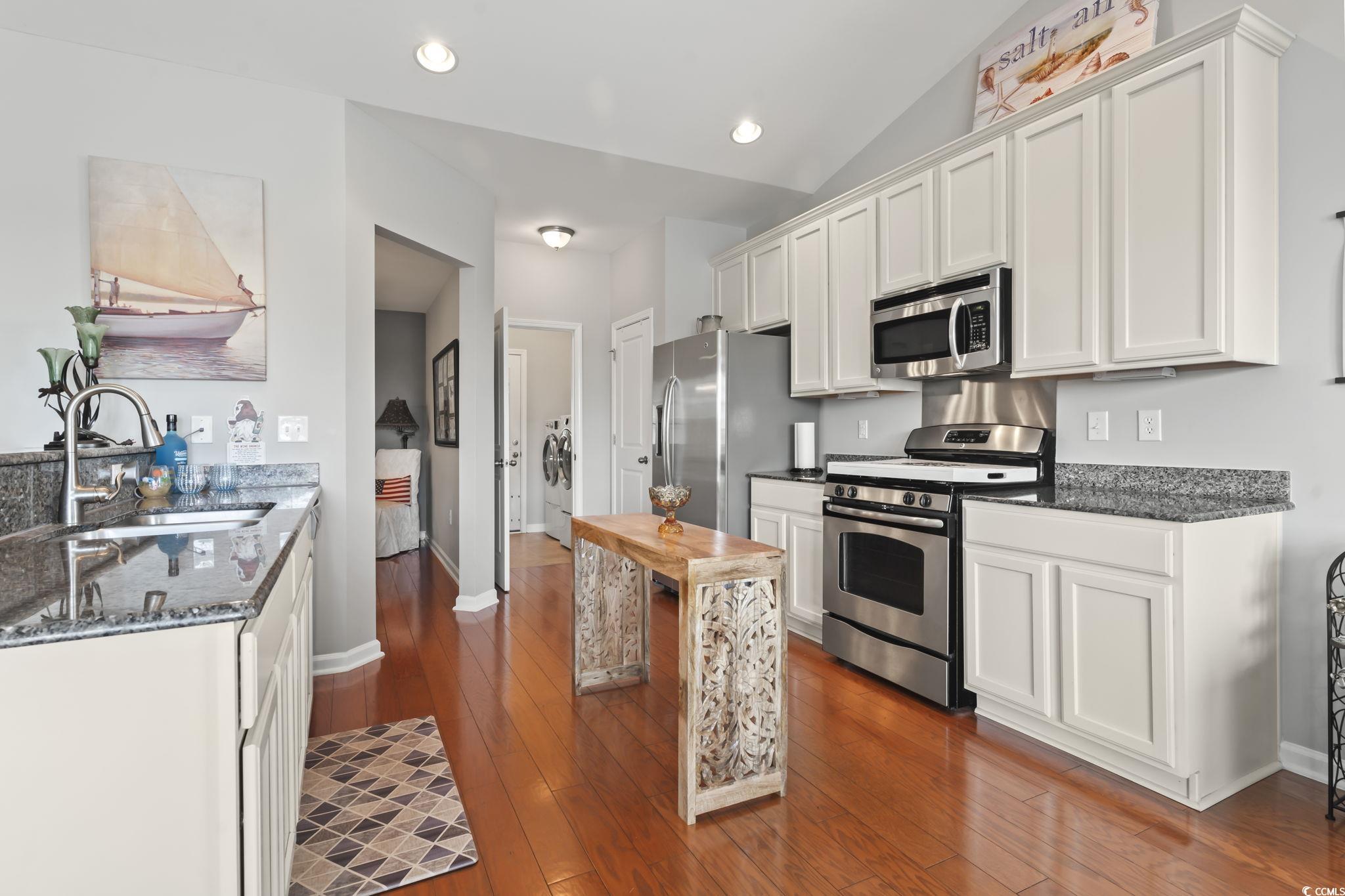 5060 Prato Loop Myrtle Beach, SC 29579 - Photo 12 of 40 Kitchen with vaulted ceiling, sink, dark hardwood