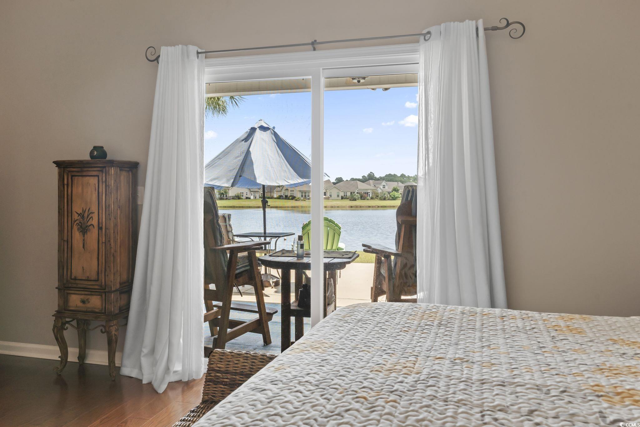 5060 Prato Loop Myrtle Beach, SC 29579 - Photo 21 of 40 Bedroom with multiple windows, a water view, hardw