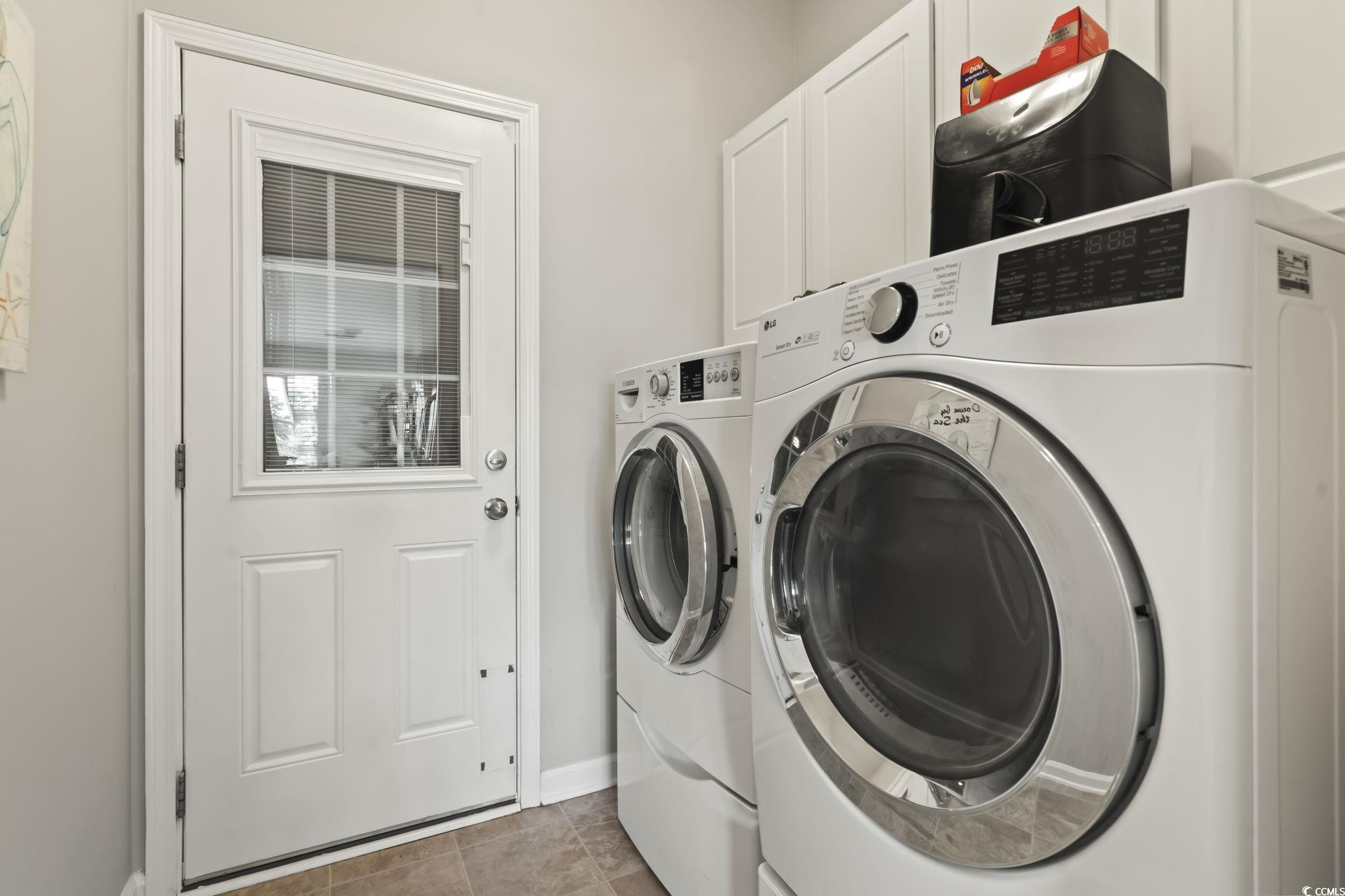 5060 Prato Loop Myrtle Beach, SC 29579 - Photo 30 of 40 Laundry room featuring cabinets, light tile patter