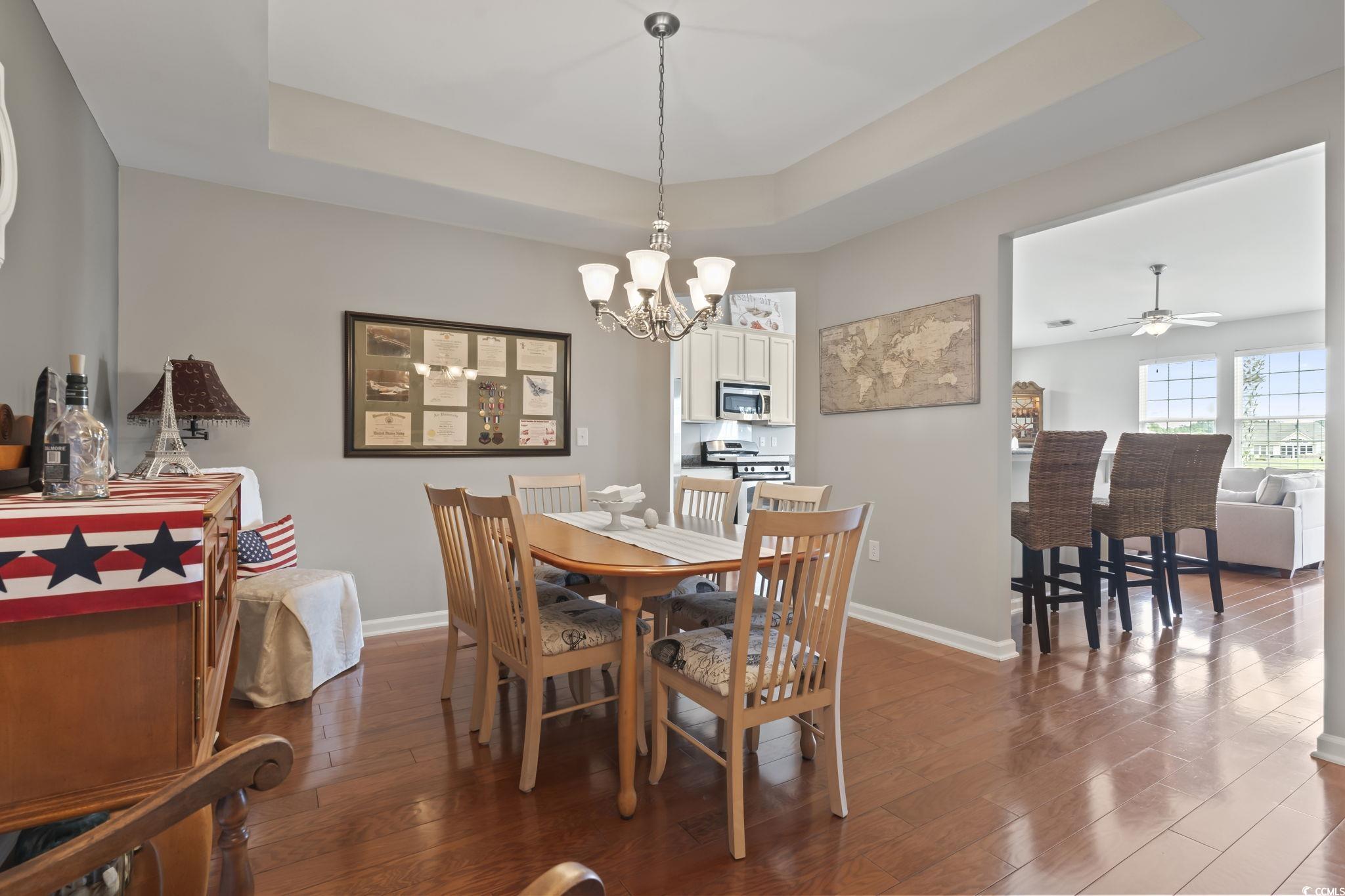 5060 Prato Loop Myrtle Beach, SC 29579 - Photo 9 of 40 Dining area featuring a raised ceiling, ceiling fa