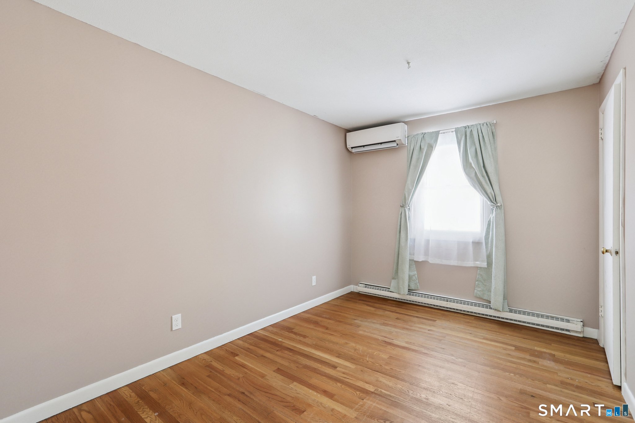 643 Bucks Hill Road Southbury, CT 06488 - Photo 13 of 25 an empty room with wooden floor and windows