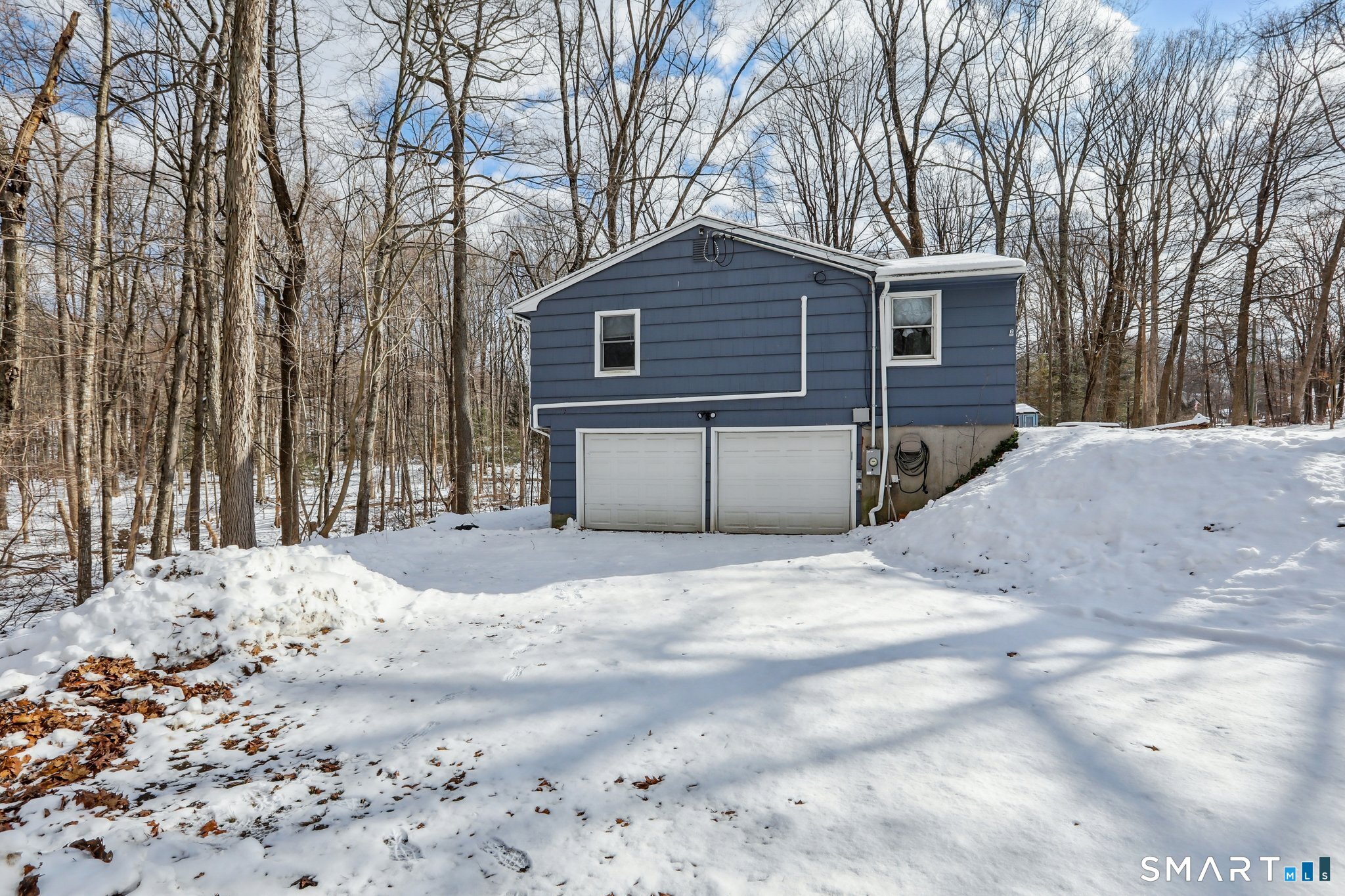 643 Bucks Hill Road Southbury, CT 06488 - Photo 21 of 25 a front view of a house with a yard covered in snow
