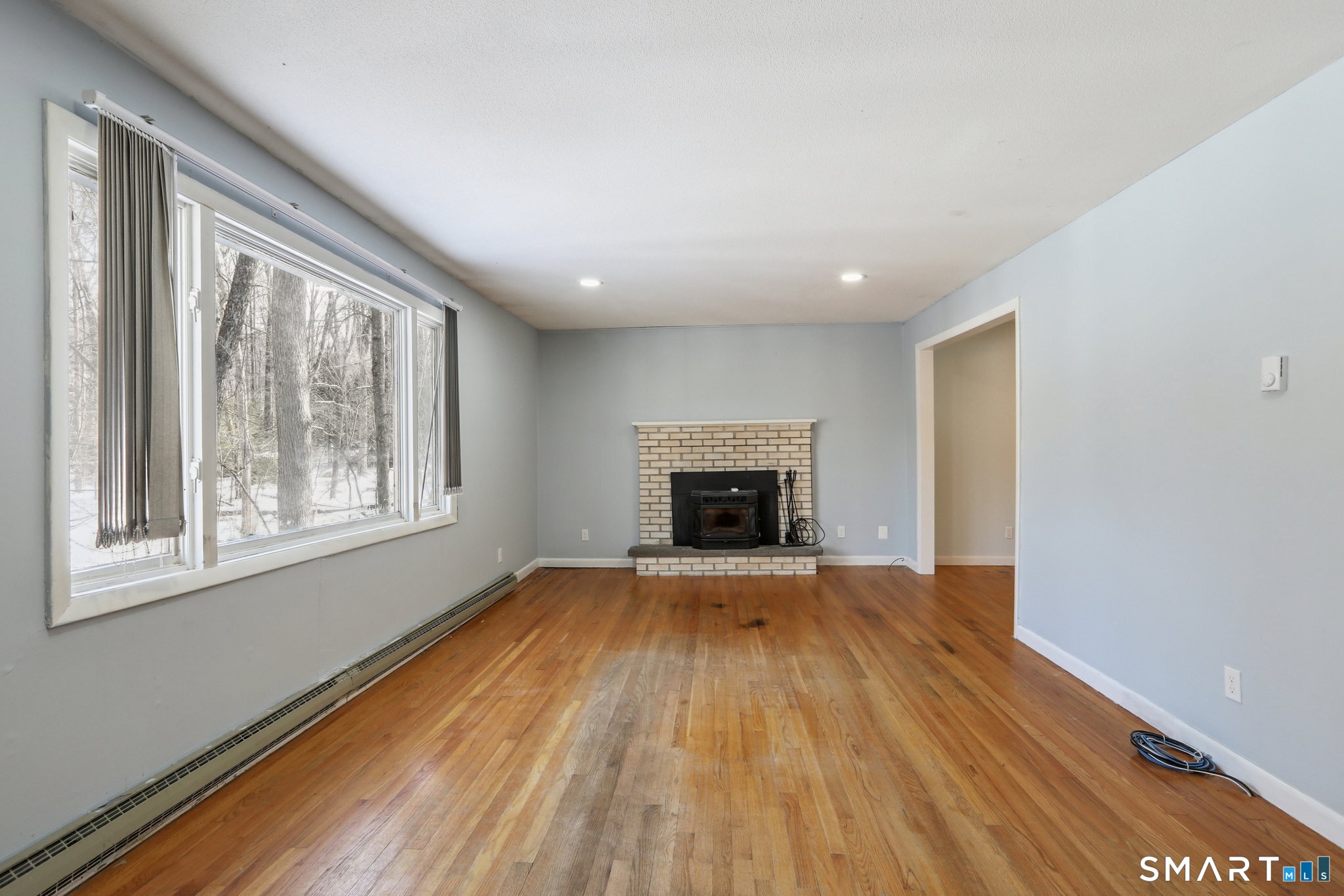 643 Bucks Hill Road Southbury, CT 06488 - Photo 4 of 25 a view of empty room with wooden floor and fireplace