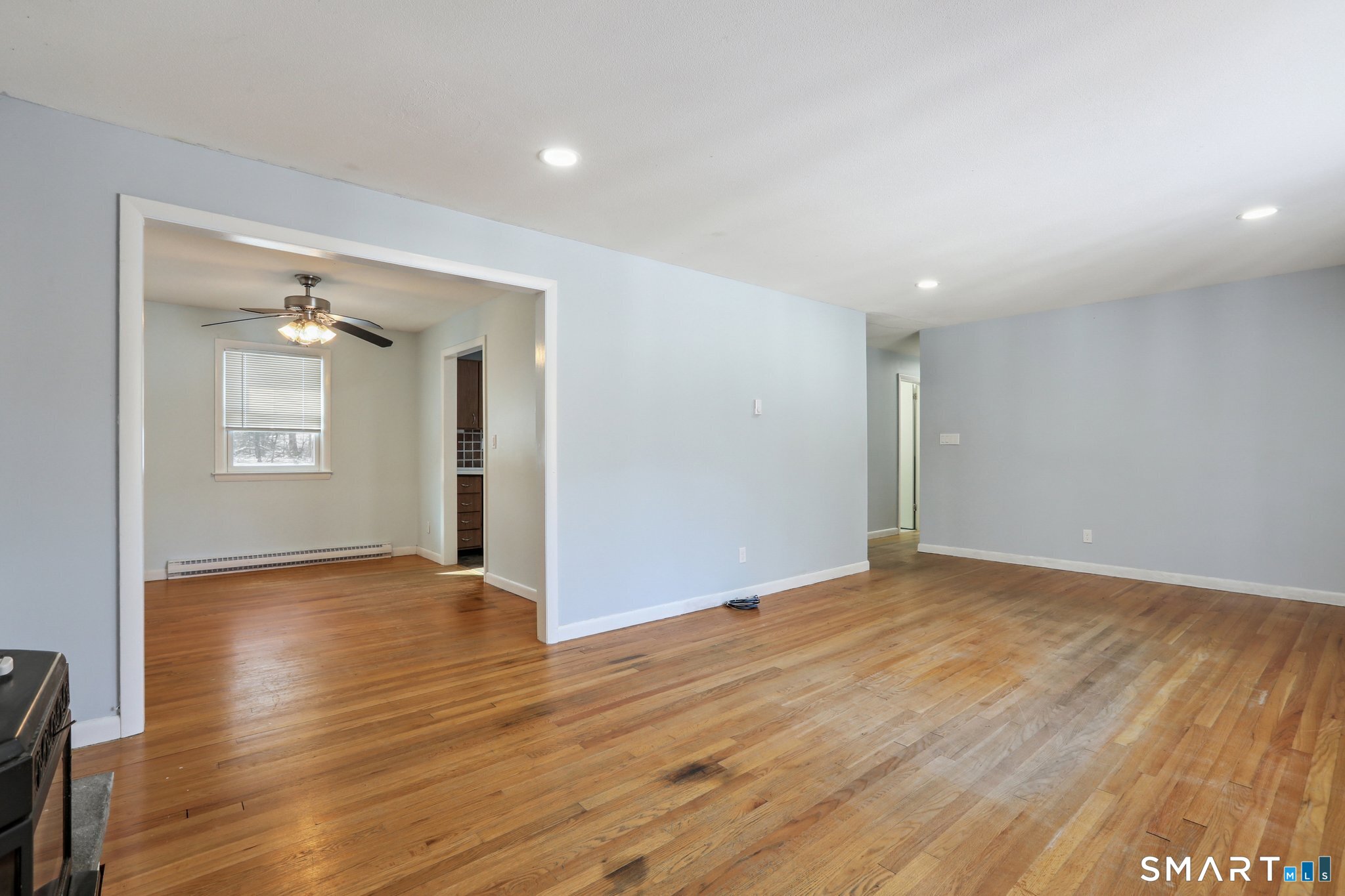 643 Bucks Hill Road Southbury, CT 06488 - Photo 5 of 25 an empty room with wooden floor and a window