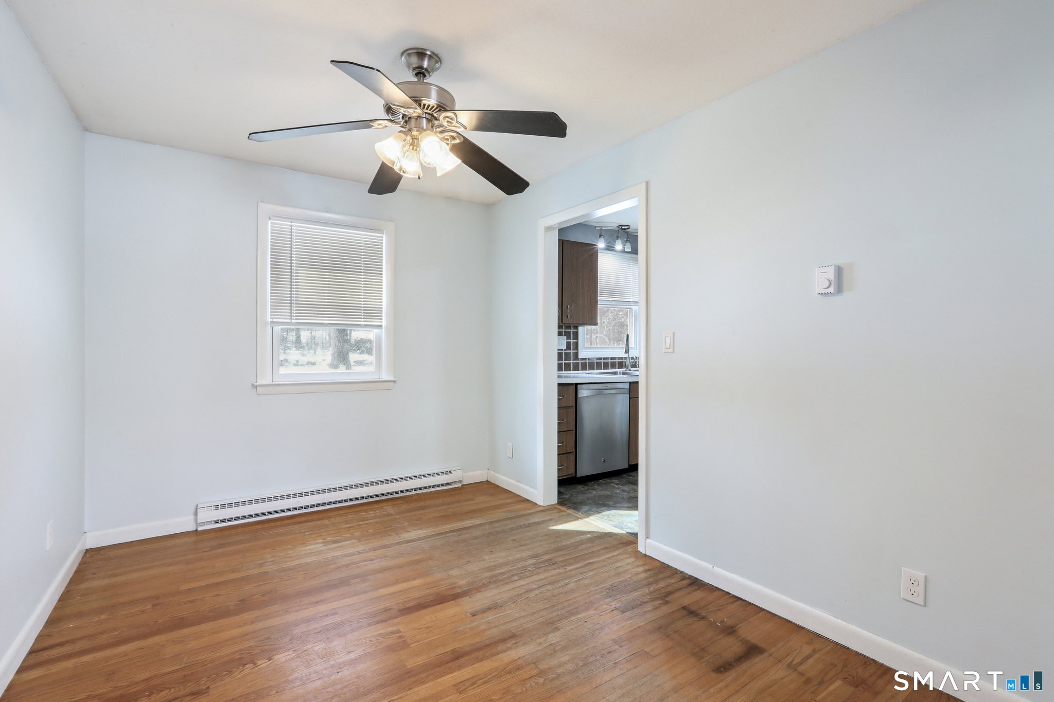 643 Bucks Hill Road Southbury, CT 06488 - Photo 6 of 25 a view of an empty room with wooden floor and a ceiling fan