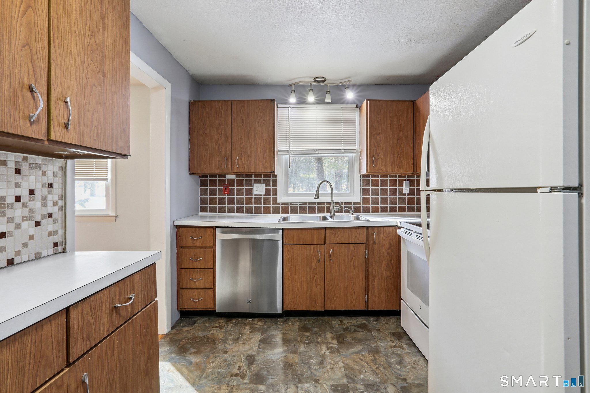 643 Bucks Hill Road Southbury, CT 06488 - Photo 9 of 25 a kitchen with sink refrigerator and cabinets