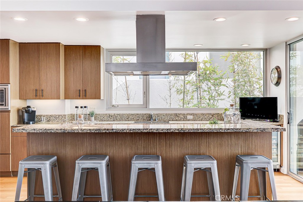 4321 Crest Drive Manhattan Beach, CA 90266 - Photo 14 of 37 a kitchen with granite countertop a sink and a window