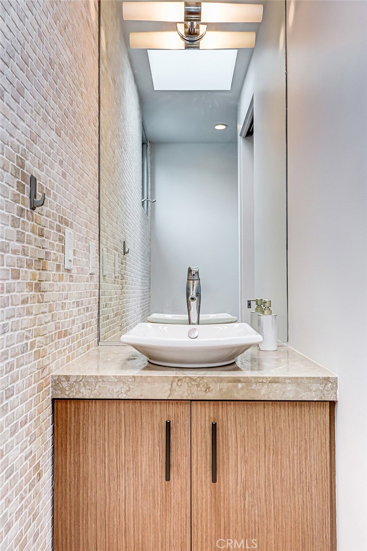 4321 Crest Drive Manhattan Beach, CA 90266 - Photo 23 of 37 a bathroom with a granite countertop sink and a mirror