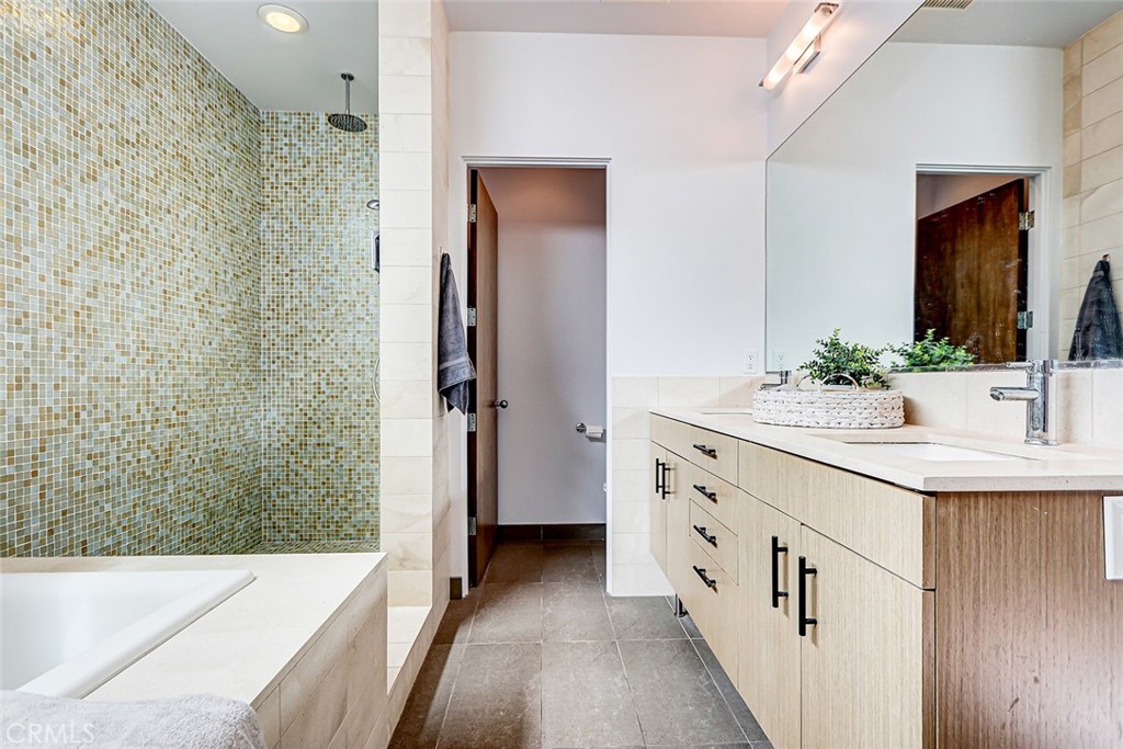 4321 Crest Drive Manhattan Beach, CA 90266 - Photo 32 of 37 a bathroom with a double vanity sink a large mirror and shower