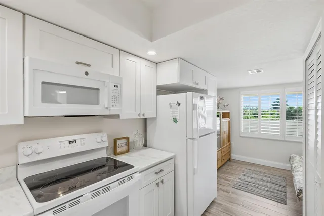 a white refrigerator freezer sitting inside of a kitchen