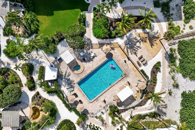 an aerial view of a house with a yard and lake view