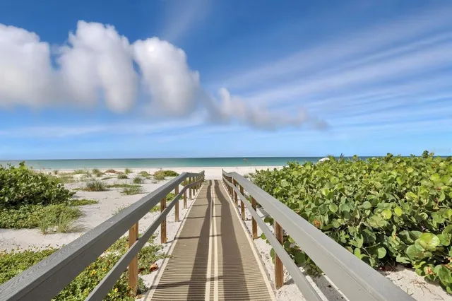 a view of balcony with wooden floor and fence