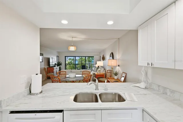 a kitchen with a sink and chandelier