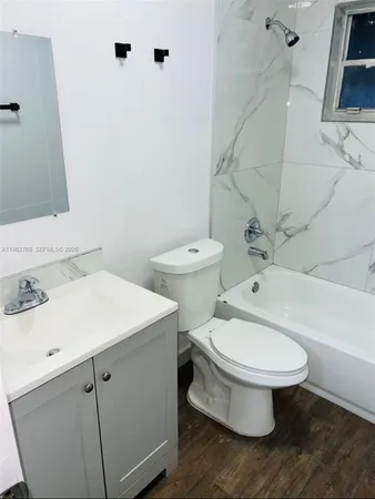 a white toilet sitting next to a bathroom sink